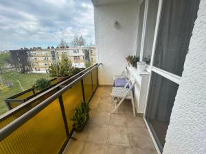 a balcony with a table and plants on a building at Digitális Detox Apartman in Tiszafüred +2 photos