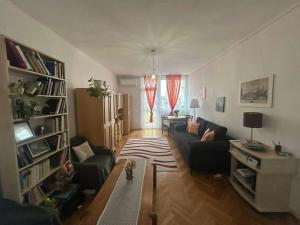 a living room with a couch and a table at Digitális Detox Apartman in Tiszafüred