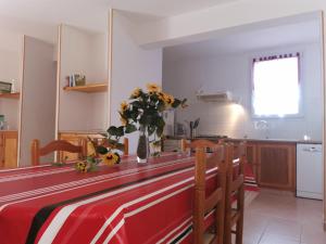 a kitchen with a table with a vase of flowers on it at Lou soula in Trilla +11 photos