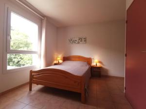 a bedroom with a bed with two lamps on it at Lou soula in Trilla