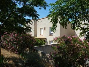 a building with pink flowers in front of it at Lou soula in Trilla