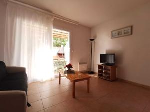 a living room with a couch and a table and a tv at Rouvenac in Trilla