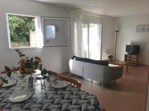 a living room with a table and a couch at Rouvenac in Trilla