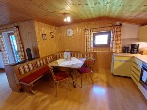 a kitchen and dining room with a table and chairs at Ferienhaus Regina in Werfenweng
