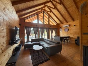 a living room with a couch and a table at Holiday House Adamo in Selno