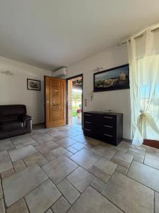 a living room with a tiled floor and a door at Guest house Luxury in Anzio