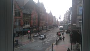 a view of a city street with cars and buildings at The Wrens in Leeds
