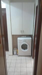 a kitchen with a washing machine in a bathroom at Stan in Bar