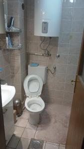 a small bathroom with a toilet and a sink at Stan in Bar