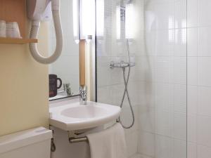 a bathroom with a sink and a shower at ibis Moulins in Moulins