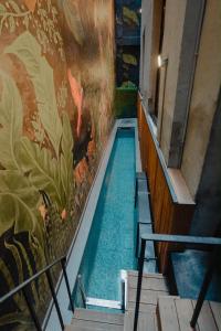 a swimming pool in a building with a painting on the wall at RUZ Hotels in Istanbul