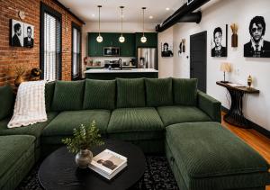 a living room with a green couch and a table at Best Intentions in Port Clinton