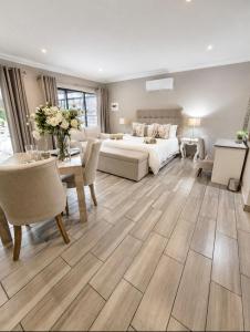 a large living room with a bed and a table at Bella Rosa in Potchefstroom +40 photos