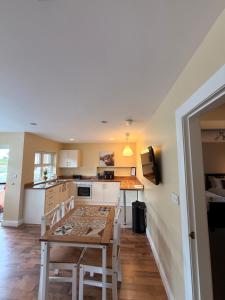 a kitchen and dining room with a table and chairs at Causeway Lodge in Bushmills