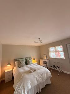 a bedroom with a bed with a dog laying on it at Causeway Lodge in Bushmills