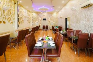 a restaurant with tables and chairs and a purple ceiling at K2 Highway Treat & Resort Unit of Lyzon in Bhadaura