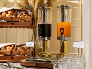 a table with two bottles of juice and bread at Midway Park Hotel in Baku