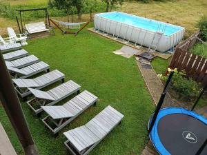 a group of lawn chairs next to a swimming pool at День і ніч in Slavske