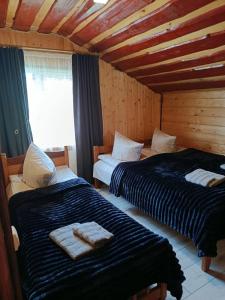 a bedroom with two beds with towels on them at День і ніч in Slavske