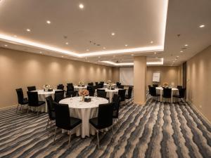 a conference room with tables and chairs in it at شير فل in Unayzah