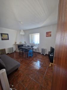 a living room with a table and a couch at Casa de Ferias no Gerês in Ferral