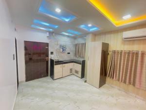 a large kitchen with a ceiling with blue lights at Radhika Cozy Studio Apartment Kitchen 2 Double Beds in Vrindāvan