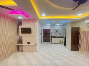 a living room with purple lights on the ceiling at Radhika Cozy Studio Apartment Kitchen 2 Double Beds in Vrindāvan
