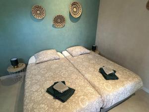 a bedroom with a bed with two towels on it at CozyCocoon Appartement in Parcey