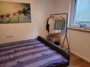 a bedroom with a bed in a room with a window at Neues 2 Zimmer Schmuckstück in Ergetsweiler