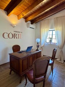 an office with a desk with a laptop on it at Herdade Da Corte in Tavira +53 photos