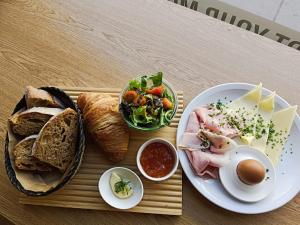 a tray of food with bread and a plate of food at Hotel Attaché in Vienna