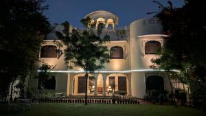 a white building with lights on it at night at Hotel Meghniwas in Jaipur