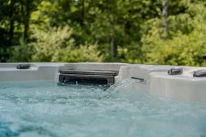 a water gun sitting on top of a pool of water at Luxury Lodge with Jacuzzi for 8 – Woodz Lodges in Heusden - Zolder