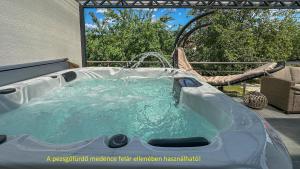 a hot tub with a water fountain in a backyard at Luxbor Villa in Eger