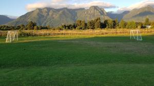 a field with a soccer field with mountains in the background at Casa Pucon in Pucón