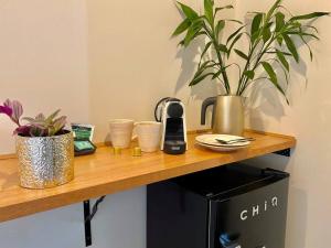 a wooden counter with plants on top of a microwave at Boutique Room - Wamoon Retreat in Yanakie