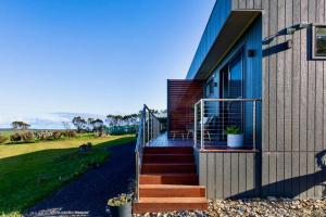 a house with a staircase leading up to a house at Boutique Room - Wamoon Retreat in Yanakie