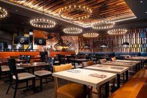 a dining room with tables and chairs and chandeliers at Harrah's Council Bluffs Hotel & Casino - A Caesars Rewards Destination in Council Bluffs