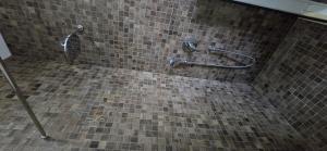 a bathroom with a tiled shower with two hand rails at Beachfront Blue Panorama in Bar