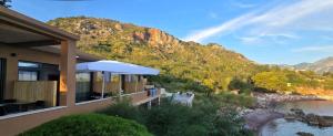 a house with a view of a river and a mountain at Beachfront Blue Panorama in Bar