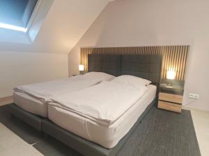 a bedroom with a large white bed and two lamps at Gästehaus Ferienwohnung Zimmer 2C oder Zimmer 2D in Jülich