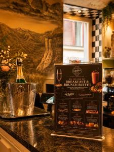 a bar with a bottle of champagne on a counter at Hotel Ottofiori in Budapest