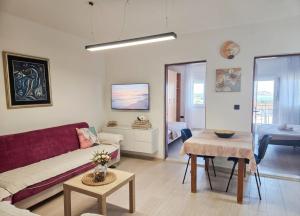 a living room with a couch and a table at Alpha Casa in Bar