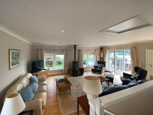 a living room with a couch and a tv at Phoenix Cottage in Kippford