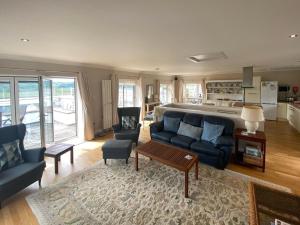 a living room with a couch and a table at Phoenix Cottage in Kippford