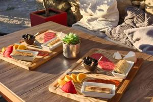 a table with two trays of different types of cheese at Ecoresort Portobali in Jugueiros