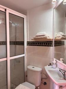 a bathroom with a toilet and a sink and a shower at Maison Sevilla in Larache +11 photos