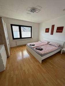 a bedroom with a bed and two windows in it at Fewo Tanja in Bestwig