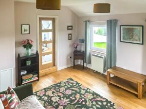 a living room with a couch and a table and a window at Hollinhaven in Blackwaterfoot +13 photos