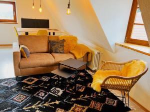 a living room with a couch and a table at Ferienwohnungen Im Eugenhaus in Rosenfeld +42 photos